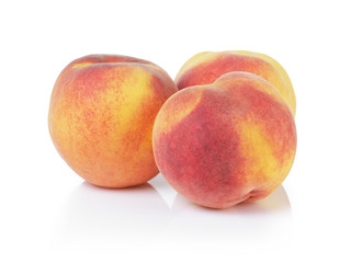 three whole ripe peaches