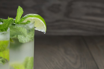 two mojito cocktails on old oak table