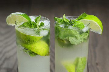 two mojito cocktails on old oak table