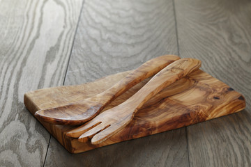 composition with olive kitchen utensils on top of oak table