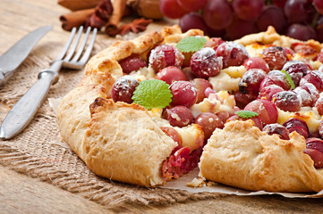 Galette with grapes and cheese sprinkled with powdered sugar