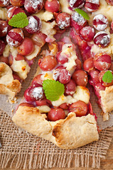 Galette with grapes and cheese sprinkled with powdered sugar