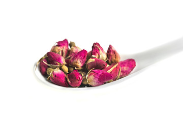 dried rose budson spoon  isolated on white background