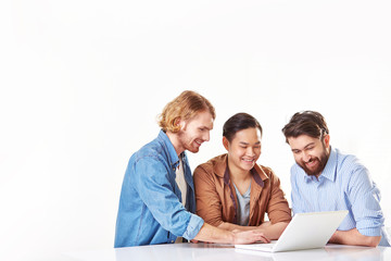 Group of cheerful men working on laptop