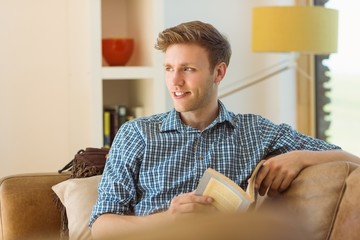 Young man reading on his couch