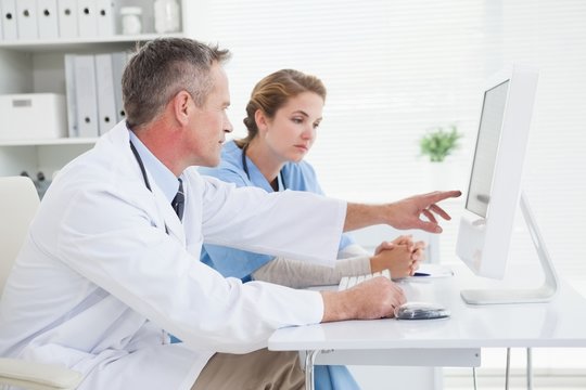 Doctor and nurse looking at a computer