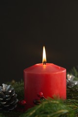 Large red candle burning bright