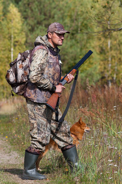 hunter with a dog in the forest
