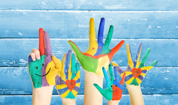 Painted hands on wooden background