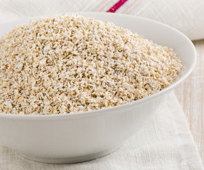 Oat bran in  white bowl