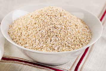 Oat bran in a white bowl