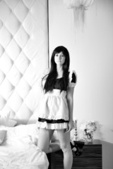 Beautiful sexy girl maid near a bed