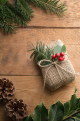 Natural holiday wrapped gift with holly berries