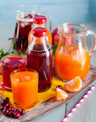 Bottles of  juices on  wooden background.