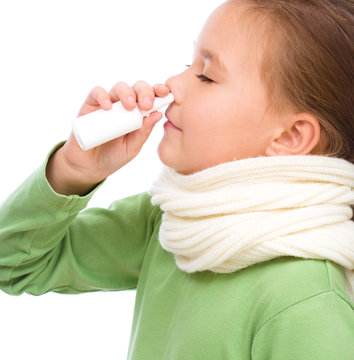 Cute girl spraying her nose