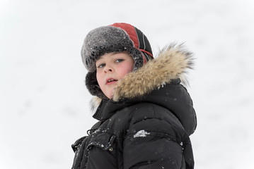 Teenage boy playing snow in winter