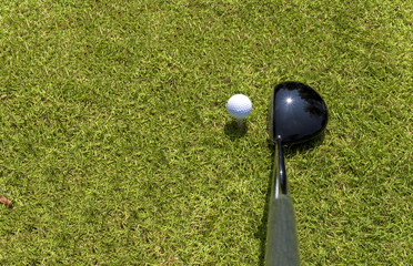 Top view of golf driver and ball on tee