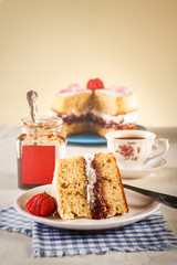 Victoria sponge cake with whipped cream and strawberries