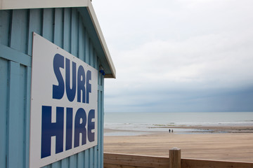 Surfing gear advertised to a desserted beach