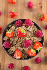 Bran flakes with fresh raspberries and strawberries