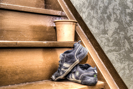 Old children's shoes on a stairway