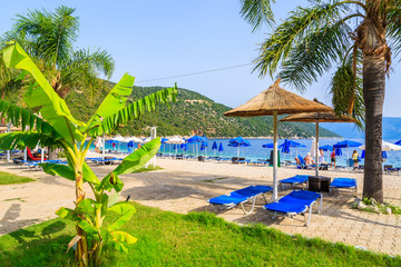 Sunbeds with umbrellas on Antisamos beach on Kefalonia island