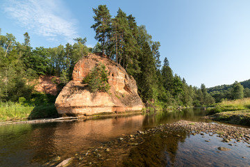 Fototapeta premium river with reflections in water and sandstone cliffs