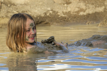 Girl taking a mud bath