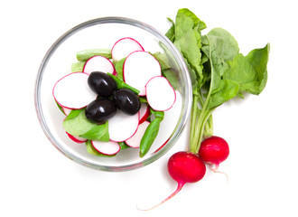 Salad radishes in bowl on white background from above