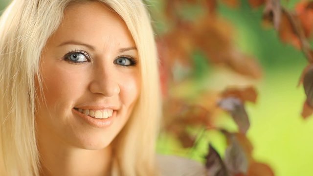 Beautiful, blonde young woman in the garden