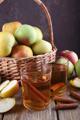 still life with apple cider and fresh apples on wooden table