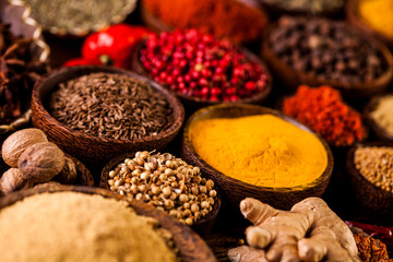 Colorful spices in wooden bowls