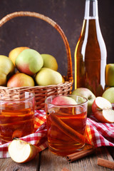 still life with apple cider and fresh apples on wooden table