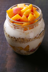 Healthy breakfast - yogurt with  fresh peach and muesli served