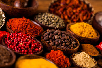 Colorful spices in wooden bowls