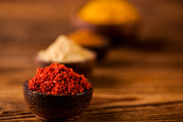 Colorful spices in wooden bowls