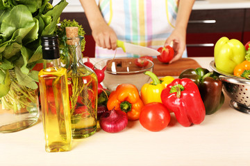 Woman cooking vegetable salad in kitchen