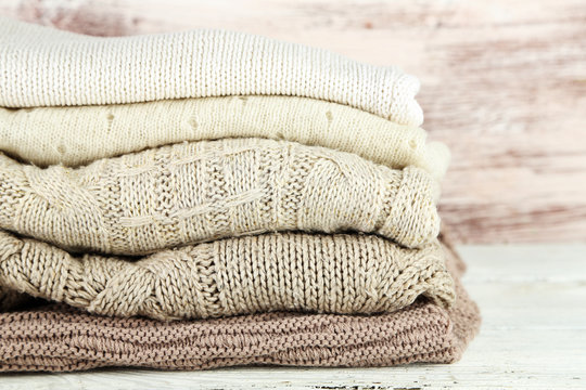 Knitting clothes on wooden background