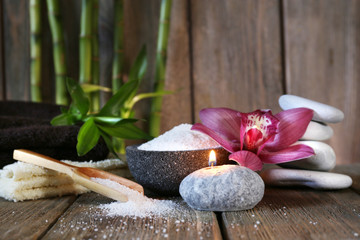 Spa set on wooden surface on wooden wall background