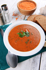 Delicious lentil cream-soup on table close-up