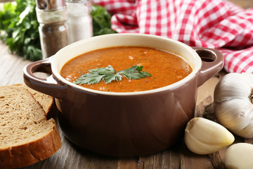 Delicious lentil cream-soup on table close-up