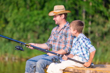 boy and his father fishing togethe