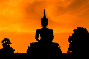 silhouette big buddha statue sitting on sunset