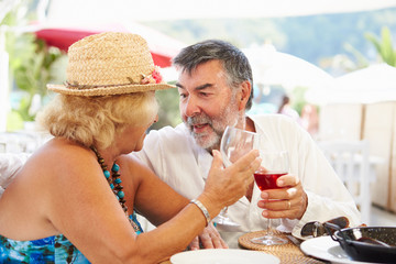 Senior Couple Enjoying Meal In Outdoor Restaurant