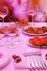Buffet table with dishware waiting for guests