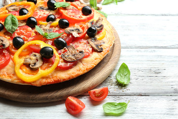 Delicious pizza served on wooden table