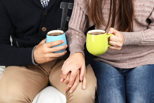 Loving couple with hot drinks