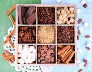 Wooden box with set of coffee and cocoa beans, sugar cubes,