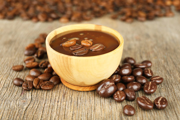 Coffee beans with chocolate glaze on wooden background