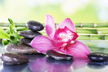 Spa stones, bamboo branches and lilac orchid